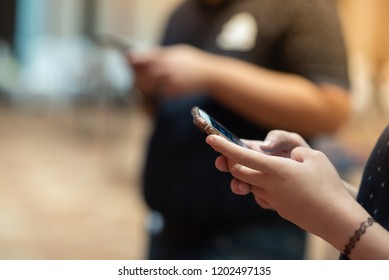 Closeup shot of a woman using a mobile phone.