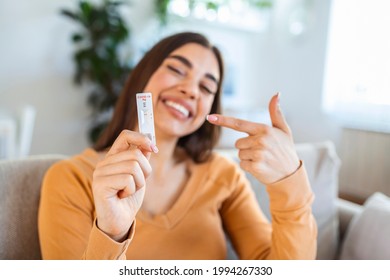 Close-up shot of woman's hand holding a negative test device. Happy young woman showing her negative Coronavirus - Covid-19 rapid test. Focus is on the test.Coronavirus - Shutterstock ID 1994267330