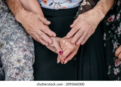 A Closeup Shot Of Women's Hands From Different Generations Together