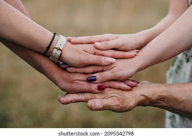 A Closeup Shot Of Women's Hands From Different Generations Together