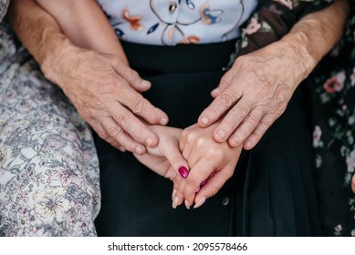 A Closeup Shot Of Women's Hands From Different Generations Together