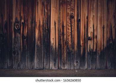 A Closeup Shot Of A Wood Fence With Charred Base