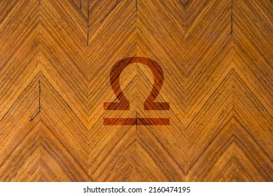 Close-up shot of a wooden surface engraved with a zodiac sign, especially the sign of Libra