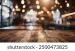 A close-up shot of a wooden table top in focus with a blurred background of warm, bokeh lights in a restaurant setting.