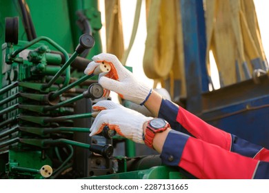 Close-up shot of a worker operating a crane at a construction site. to lift heavy construction equipment at the construction site