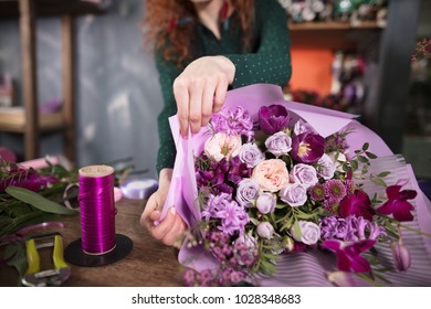 closeup shot of wrapping bouquet of flowers at flower market - Powered by Shutterstock