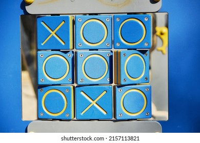 A closeup shot of XO game for kids on a playground