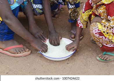 Close-Up Shot of Young African Boys and Girls Eating Outdoors