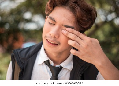 Closeup Shot Of A Young Man With A Dust Particle In His Eye. Irritated Or Sore Eyes.