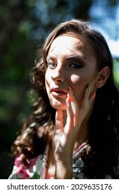 A Closeup Shot Of A Young Woman Posing Under A Tree Shade