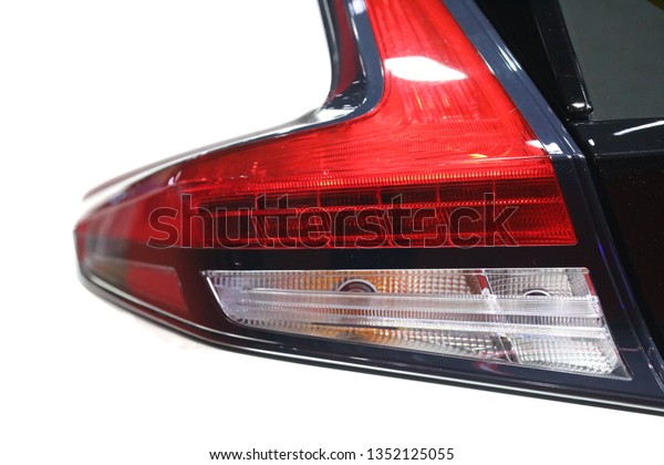 Close-up shots of the\
sparkling tail lights of a luxury sports car with light reflections\
on the rear bumper Concept of car details and color protection\
background