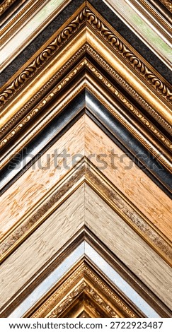 A close-up showcases several types of frames in a diagonal composition. Frames have gold, silver, and wood finishes. It's perfect for adding decorative accents or copy-space for design concepts.