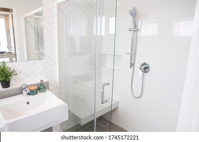 Close-up Of Shower Fixtures Of A Bathroom With Glass Door And Chrome Handle.