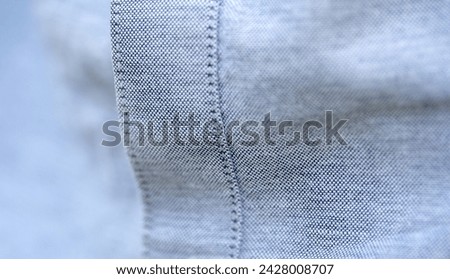 Close-up showing the fine texture and stitching of gray fabric of a quality shirt clothes and clothing materials object structure macro detail, extreme closeup, nobody Quality weave, premium materials