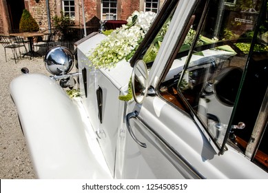 Close-up from the side of a decorated white old-timer outdoor