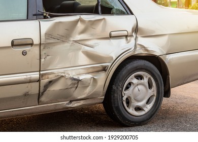 Close-up Of A Side Door Of A Golden Bond Car That Was Demolished In A Collision Accident With Another Vehicle.