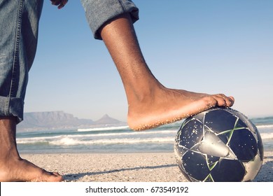 Closeup Side View Of Barefeet With Soccer Ball At Beach