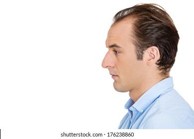 Closeup Side View Profile Head Shot Portrait Of Sad Bothered Stressed Serious Young Man Depressed About Something Or Someone, Isolated White Background. Negative Emotion Facial Expression Feeling