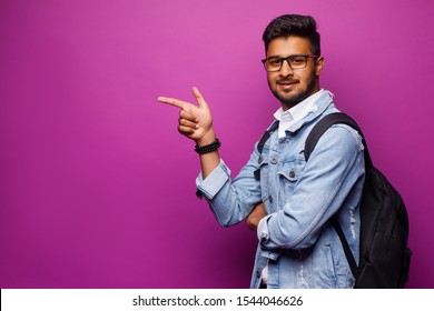 Closeup side view profile portrait, young man pointing, surprised by something or someone, isolated white background. Positive human emotion facial expression feelings, attitude, reaction.