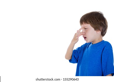 Closeup Side View Profile Portrait Of Kid Pinching And Holding Nose Because Something Stinks, Isolated On White Background With Copy Space