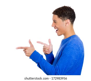 Closeup Side View Profile Portrait Of Young Man, Laughing, Pointing With Finger At Someone Or Something, Isolated On White Background. Positive Face Expressions, Emotions, Feelings, Attitude, Approach