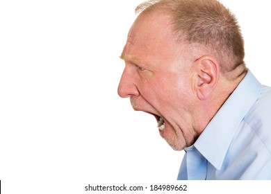 Closeup side view profile portrait, mad, upset, senior mature man, funny looking business man, open mouth yelling, isolated white background. Negative emotion facial expression, reaction