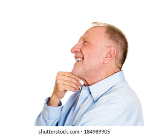 Closeup side view profile portrait, senior mature man, daydreaming about something that makes him happy, looking up, isolated white background. Positive human emotion facial expression feelings.