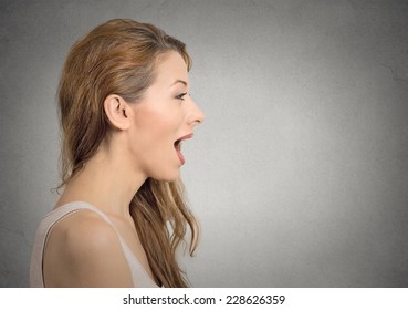 Closeup Side View Profile Portrait Woman Talking With Sound Coming Out Of Her Open Mouth Isolated Grey Wall Background. Human Face Expression Emotions. Communication, Information, Intelligence Concept