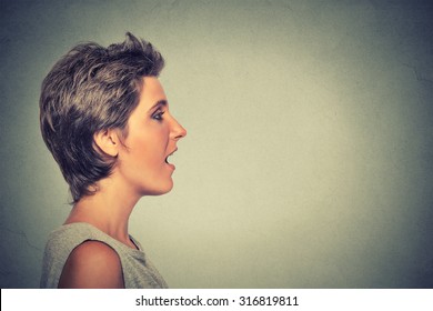 Closeup Side View Profile Portrait Woman Talking With Sound Coming Out Of Her Open Mouth Isolated Grey Wall Background. Human Face Expression Emotions. Communication, Information, Intelligence Concept