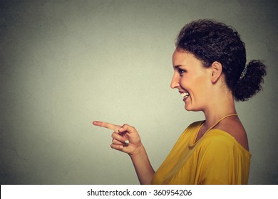 Closeup Side View Profile Portrait Of Attractive Woman Pointing And Laughing At Someone Or Something Isolated On Gray Wall Background