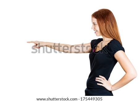 Closeup side view profile portrait of pretty young woman laughing  pointing finger at someone or something, isolated white background. Positive emotion facial expression feelings, attitude, reaction