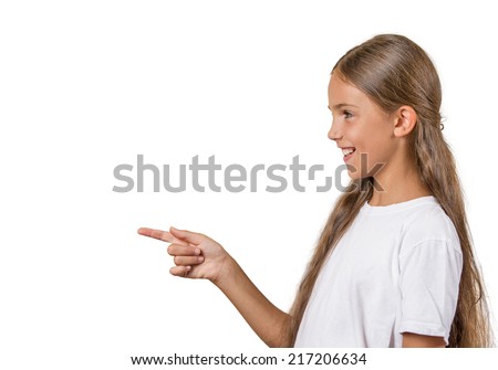 Closeup side view profile portrait, teenager girl pointing finger surprised by something, someone isolated white background with copy space. Positive human emotion facial expression feeling reaction