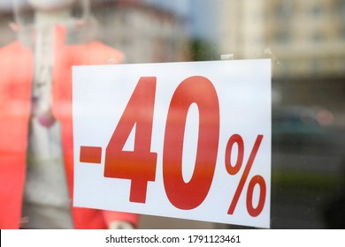 Close-up of sign with 40 percent announcement, shopping on reduced prices. Label of shop, announcement of discount or clearance. Selloff for clients, sellout reduction