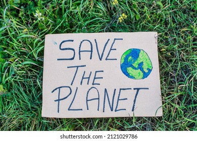 A Closeup Of A Sign That Says Save The Planet, On A Background Of Grass - Powered by Shutterstock