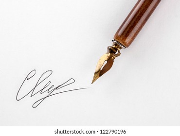 Closeup Of Signature (fake, Not Real) And Ink Pen, Isolated On White