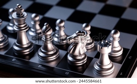 Close-up of silver chess set on chessboard. Chessmen 