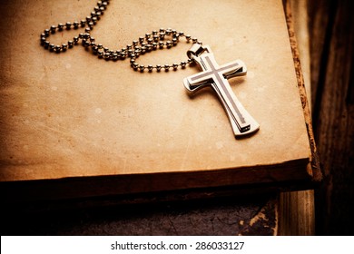 Closeup of silver Christian cross on bible Stock Photo