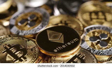Closeup Of A Silver Ethereum Crypto Coin On Top Of Other Crypto-currency.