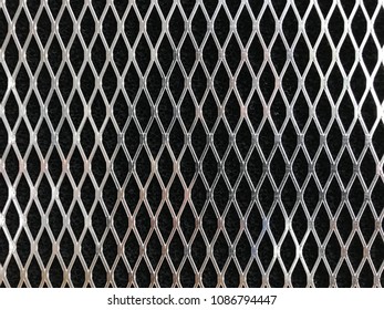 Closeup Of Silver Metal Mesh On Black Background From Fume Extractor Filter To Be Used As Textured Background Or Backdrop