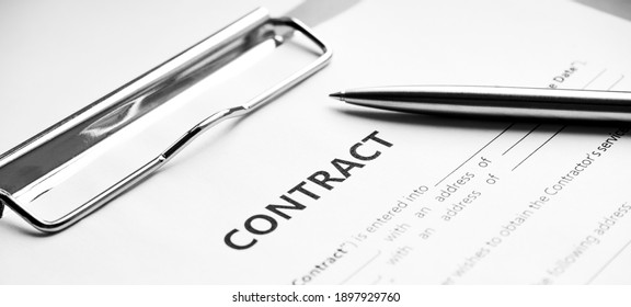 Close-up of a silver pen on docunent contract. Legal contract signing, buy sell real estate contract agreement sign on document paper with black pen - Shutterstock ID 1897929760