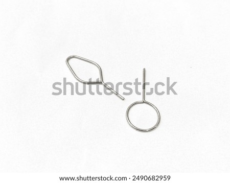 Close-up of a SIM card ejector, isolated on a white background, emphasizing its precise design and essential function. Perfect for technology accessories, mobile phone tools, and electronic device