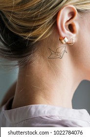 Closeup Of A Simple Behind The Ear Tattoo Of A Young Woman