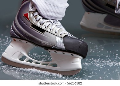 Close-up Of Skates On Player Feet During Ice Hockey