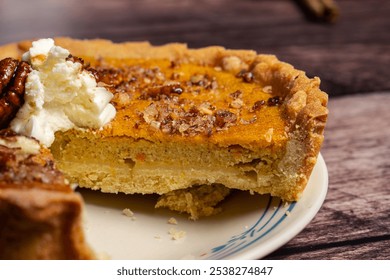 A close-up slice of pumpkin pie topped with a dollop of whipped cream and candied pecans, highlighting the smooth filling and golden crust. Perfect for capturing the warmth of fall flavors  - Powered by Shutterstock