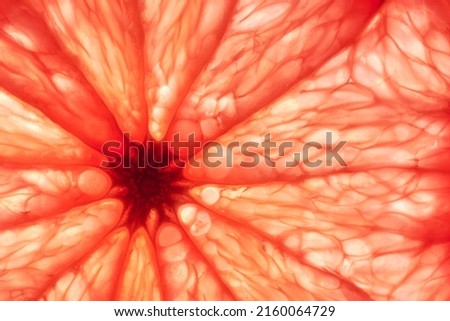 Close-up of sliced ripe grapefruit, macro, creative background.