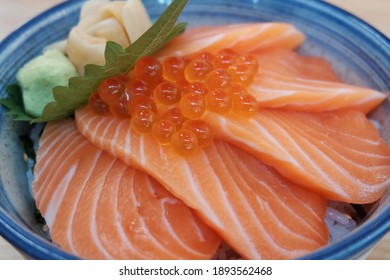 Closeup Sliced Salmon Top With Ikura Decorated With Green Shiso And Fresh Wasabi Served At Local Japanese Restaurant. Popular Traditional Seafood Menu At Fish Market. Sliced Ginger For Too Oily Menu