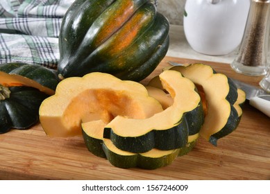 Closeup Of Sliced Uncooked Acorn Squash On A Cutting Board