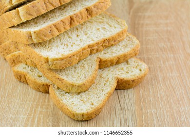 Closeup of sliced whole wheat bread on wood table,selective focus.