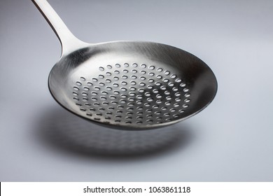 close-up of a slotted spoon on a white background - Powered by Shutterstock