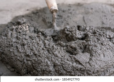 Closeup Of A Small Batch Of Wet Concrete And Shovel. Shot Outdoors. For A DIY Project Or Repair. Manual Labor.